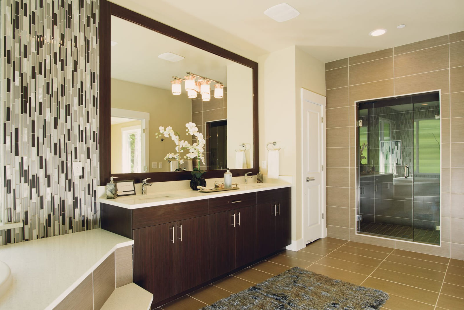 A large custom mirror fitted above a bathroom vanity.