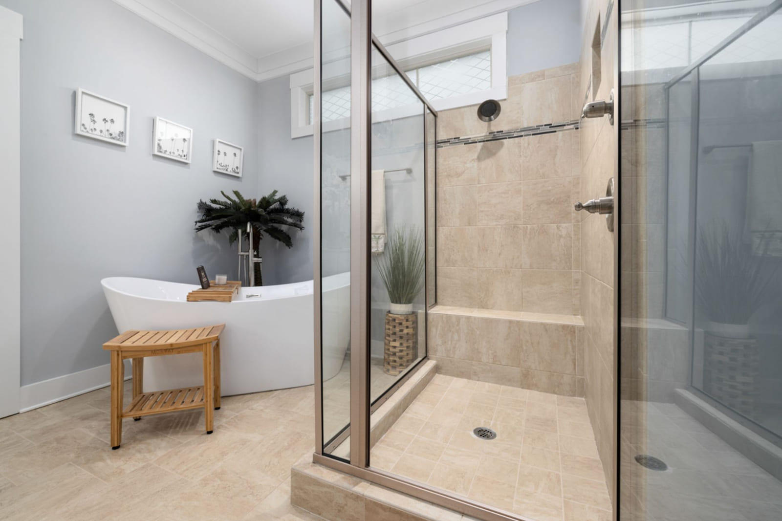 A glass shower enclosure installed in a finished bathroom.